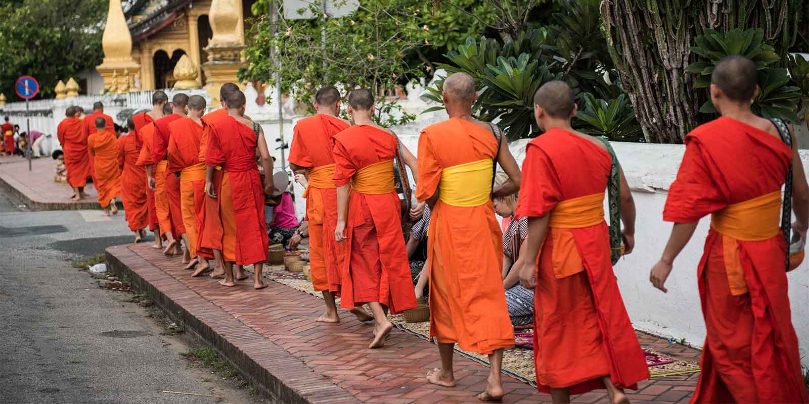 Buddhist monks walking outside temple in Laos