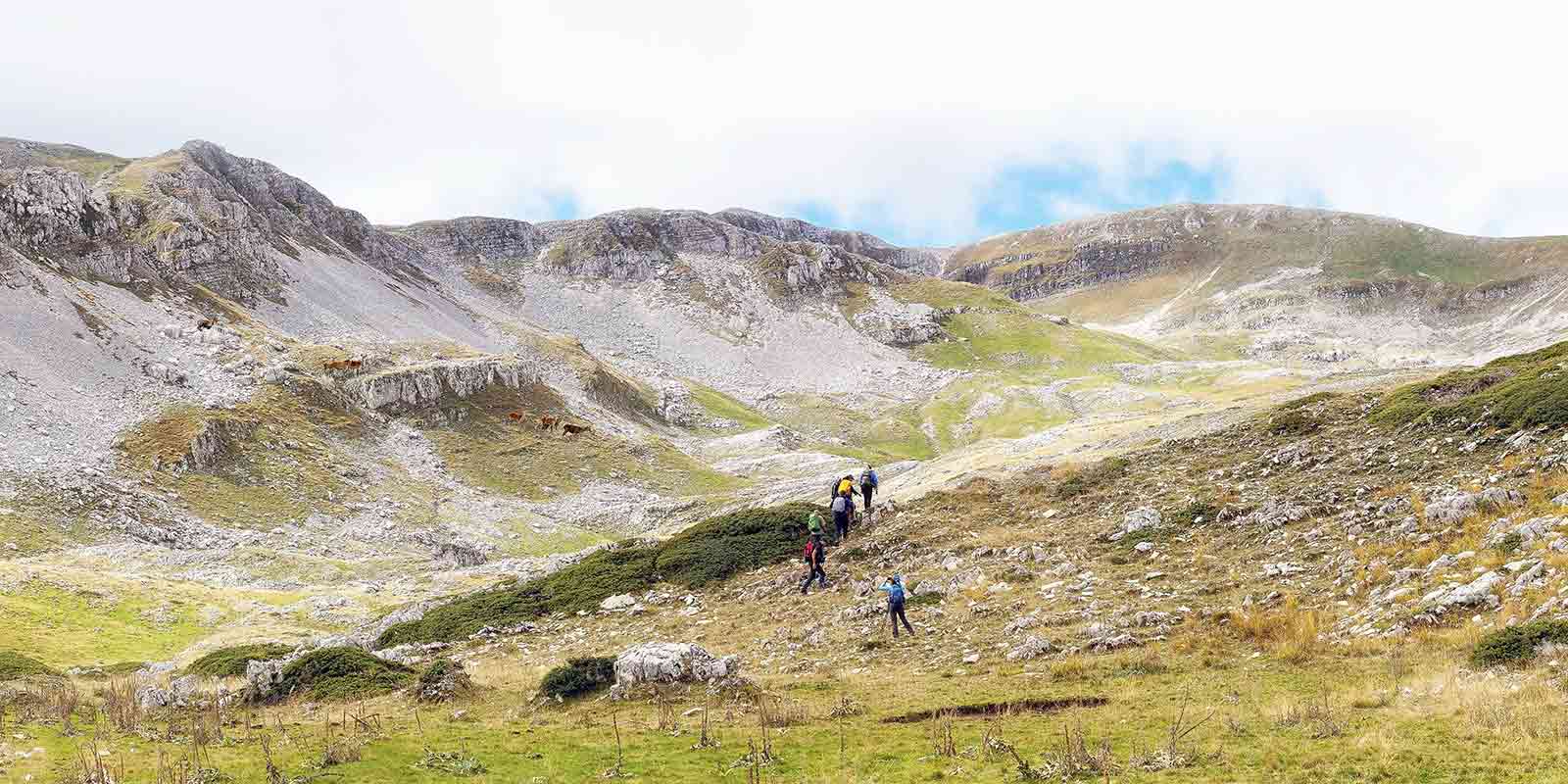 Hikers walking in a valley in the Abruzzo region of Italy