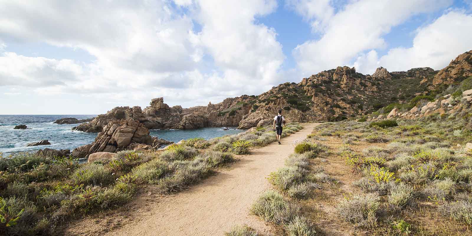 Hiker on coastal trail in Sardinia