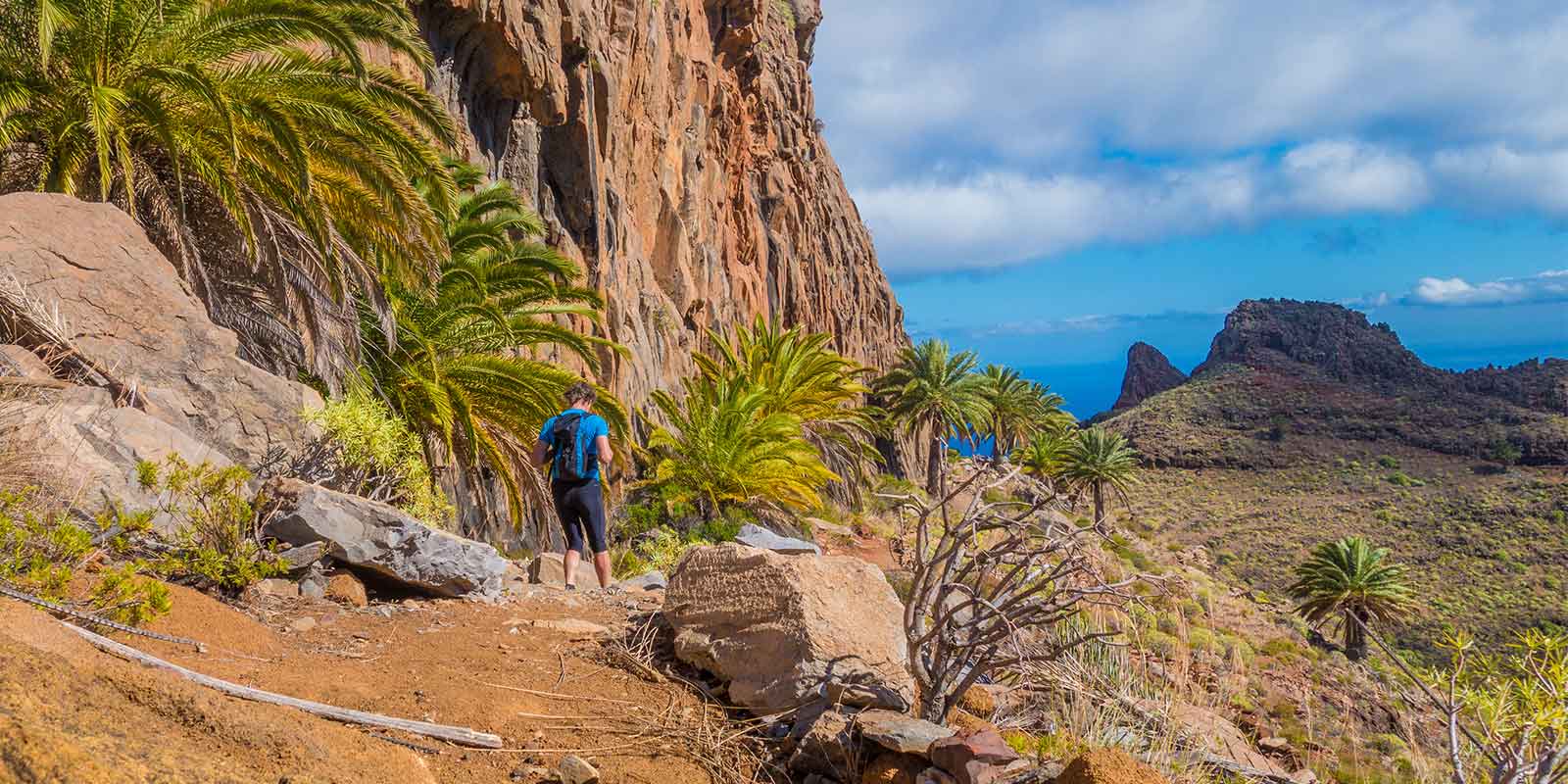 Hiker in the mountains of the Canary Islands, heading towards the coast