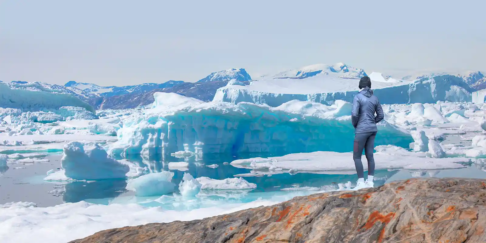 Hiker enjoying the ice view in Tiniteqilaaq, Greenland, Arctic