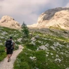 Man hiking along a mountain trail in Triglav National Park, Slovenia.