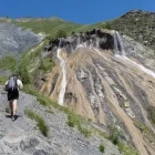 Hiker at the cascade de la pisse, Champsaur Valley, France.