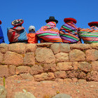 Quechua ladies sitting on an Inca wall in Peru. 