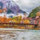 Walking over a bridge in Kamikochi National Park, Japanese Alps