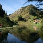 Walkers by Natural Badeteich Lake in Austria.