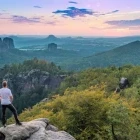 Hiker admiring the view from Carolafelsen to Grosse Dom, Saxon Switzerland National Park, Germany.