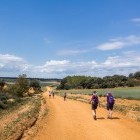 Hikers on country track on French Way of Camino de Santiago