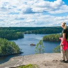 Hiker admiring lake view in Finland