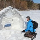 Man building an igloo in Finland