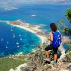 Hiker admiring the view over bay in Tavolara in Sardinia