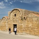 Hikers outside an ancient church on the Sinis Loop in Sardinia