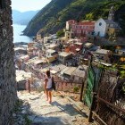 Woman walking down steps of Vernazza town in Italy
