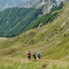 Hikers walking through a mountain valley in Montenegro
