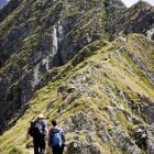 Couple hiking Moldoveanu Peak in Romania