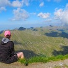 Hiker looking at the view from Moldoveanu Peak in Romania