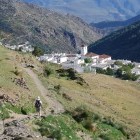 Hiking towards a village on the GR7 trail in Sierra Nevada