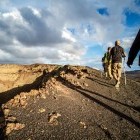 Hikers walking next to caldera in Lanzarote in the Canary Islands