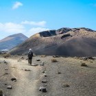 Hiker walking through Timanfaya National Park in Lanzarote, the Canary Islands