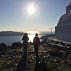Two female hikers walking on Santorini Island in Greece