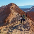 Tourists walking on rocky formations in Atacama Desert, Chile
