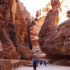 Group walking through the Siq Passageway in Petra, Jordan.