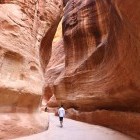 Group walking through the Siq Passageway in Petra, Jordan.