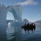 A Zodiac cruising around ice in Scoresby Sound, Greenland