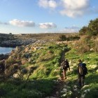 Hikers walking along the Puglia coast in Italy