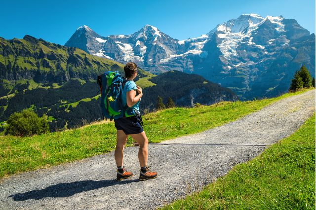 Woman walking next to mountains