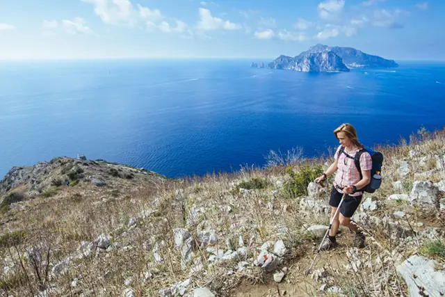 Hiker on the Path of the Gods hiking trail in the Amalfi Coast, Italy