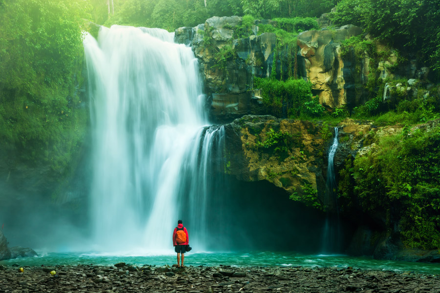 Hiker by a waterfall in Costa Rica