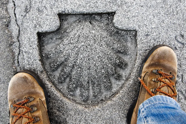 Someone stood over the mark of the Camino de Santiago trail.
