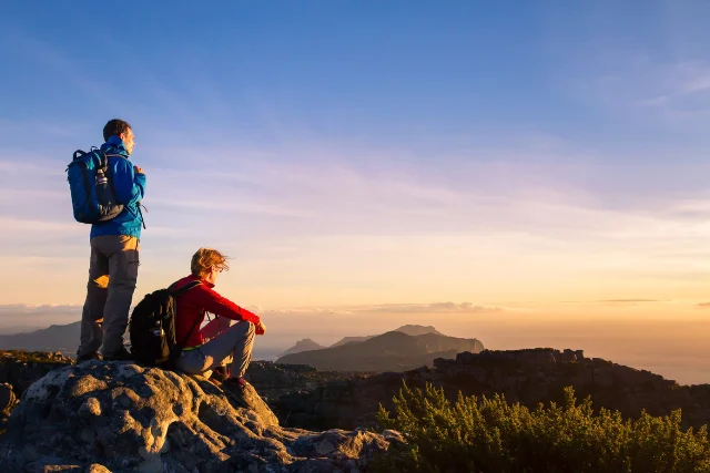 Hikers enjoying a summit view.