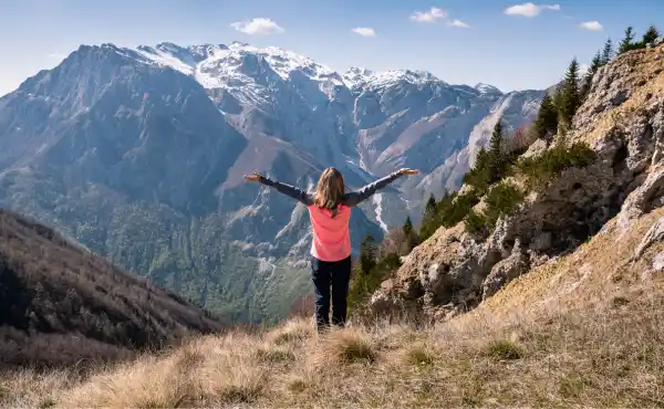 Woman admiring the mountainous landscape of Slovenia.