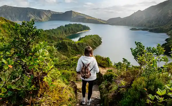 Hiker looking at Lagoa do Fogo in the Azores