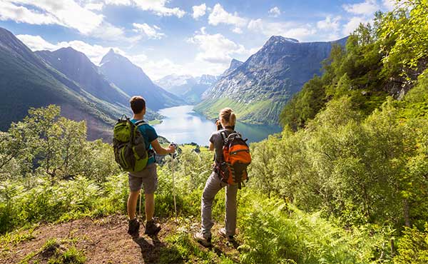 Hikers looking down at Fjord in Norway