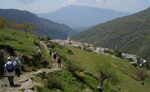 Walkers approaching a village in the Alpujarra mountains